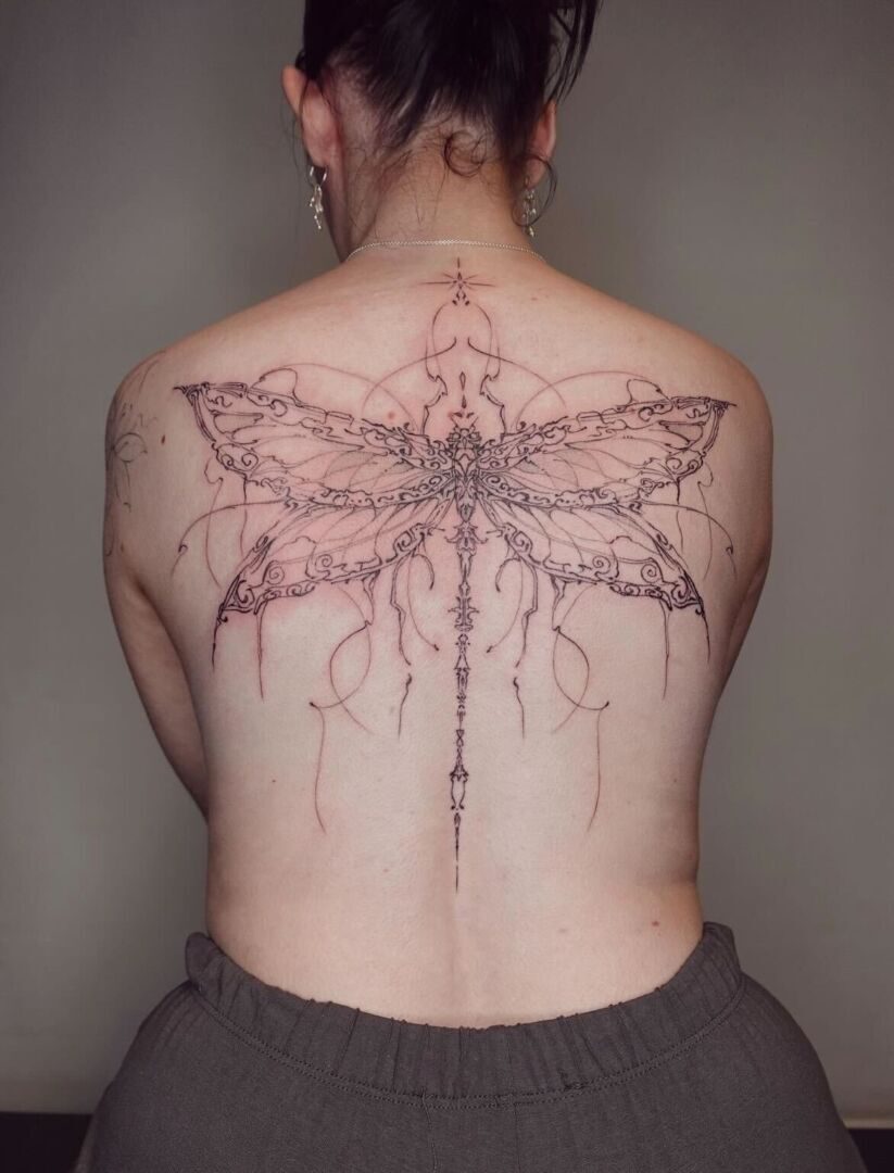 Cybersigilism tattoo on the back shaped like a butterfly
