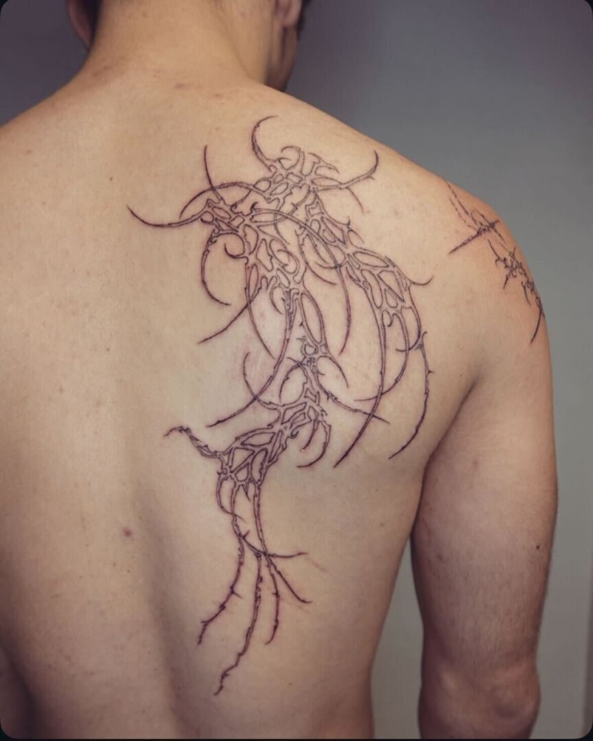 Cybersigilism tattoo on the right side of the back